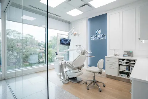 A meticulously clean, modern dental operatory with a patient chair and bright clinical lighting.